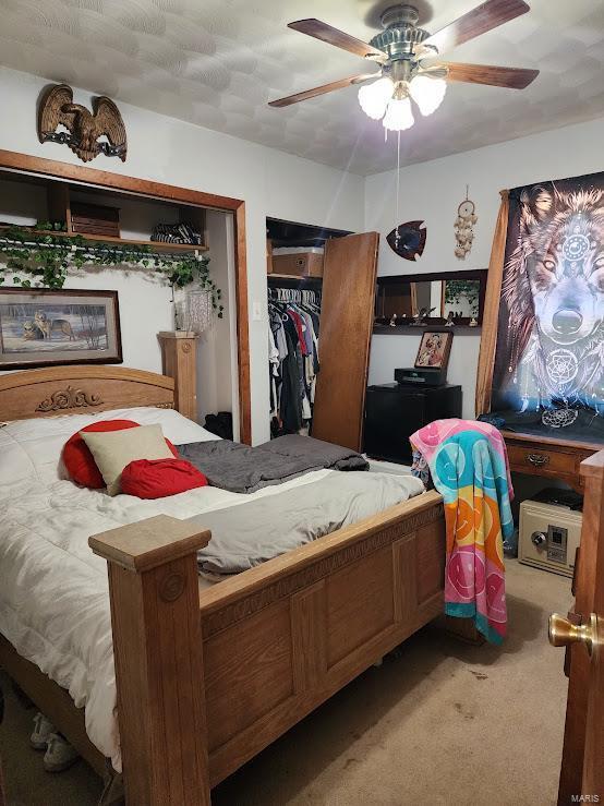 carpeted bedroom featuring ceiling fan