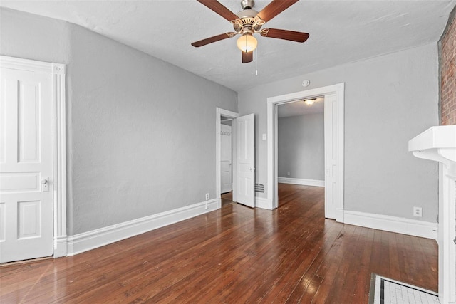 interior space with baseboards, hardwood / wood-style floors, and a ceiling fan