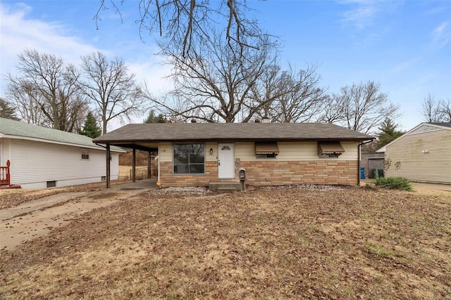 view of front of property with an attached carport, stone siding, and driveway