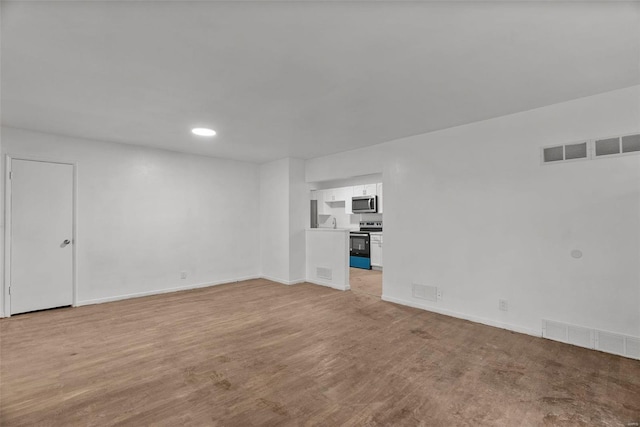 unfurnished room with visible vents, baseboards, and light wood finished floors