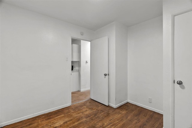 unfurnished bedroom with wood finished floors and baseboards