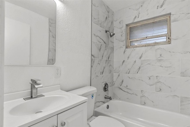 full bath featuring toilet, vanity, shower / bath combination, and a textured wall