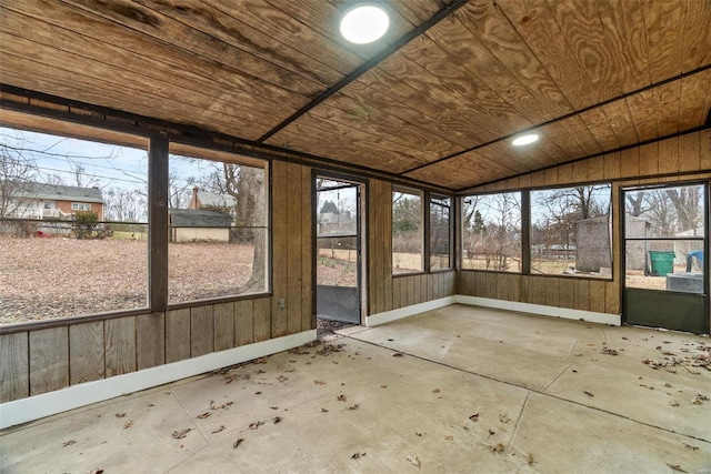 unfurnished sunroom featuring wood ceiling and lofted ceiling