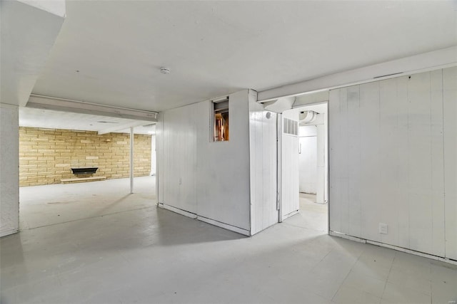 finished basement featuring brick wall