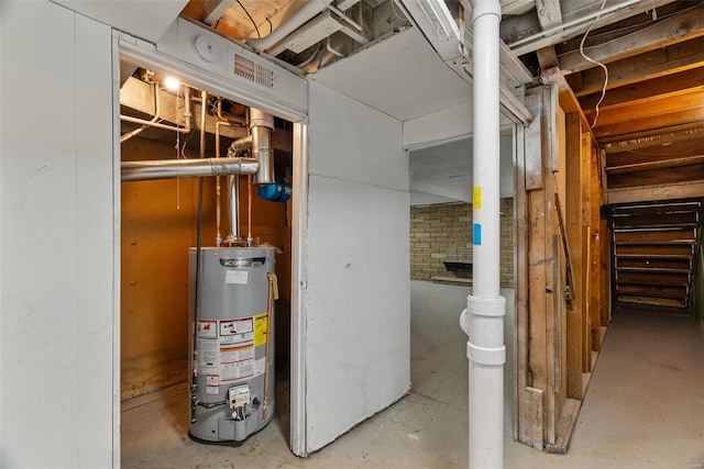 unfinished basement featuring water heater and brick wall