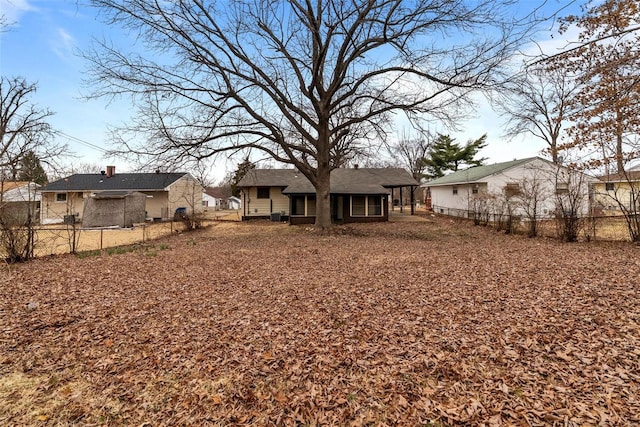 rear view of property featuring fence