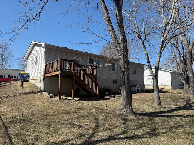 back of house with a lawn, stairs, a deck, and fence