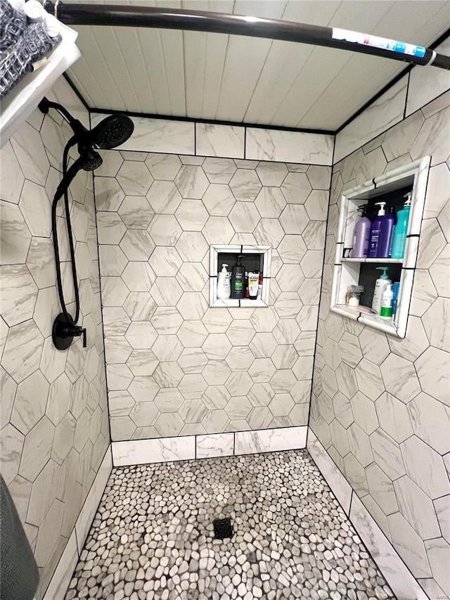 bathroom with a tile shower