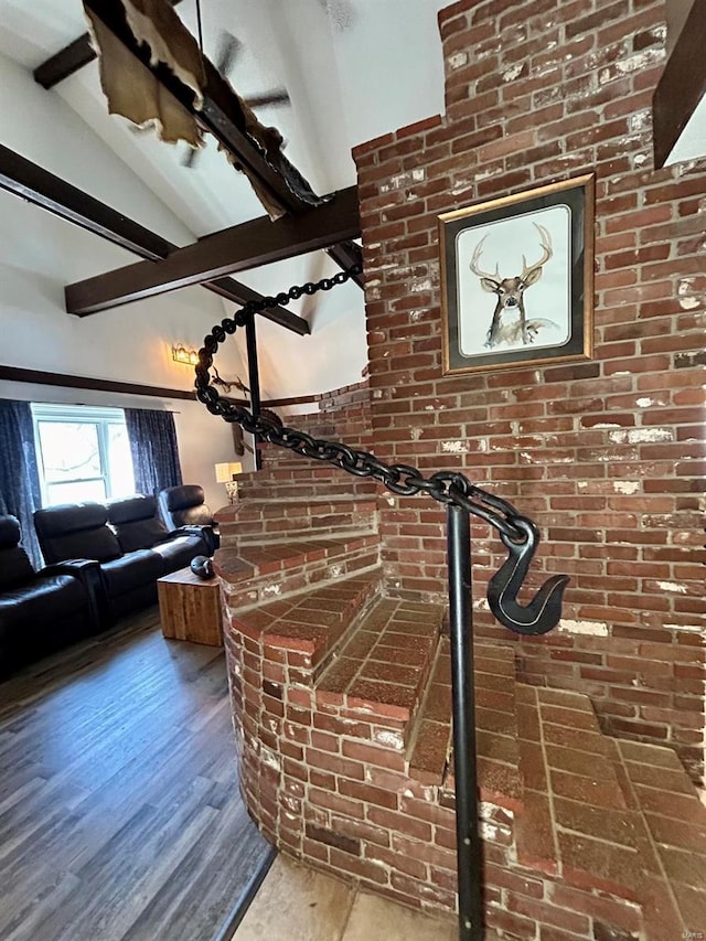 interior space with vaulted ceiling with beams and wood finished floors