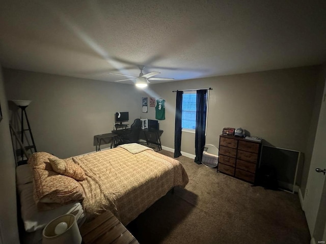 carpeted bedroom with ceiling fan, baseboards, and a textured ceiling