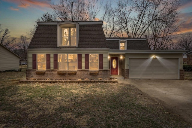 view of front of home with brick siding, mansard roof, a shingled roof, concrete driveway, and an attached garage