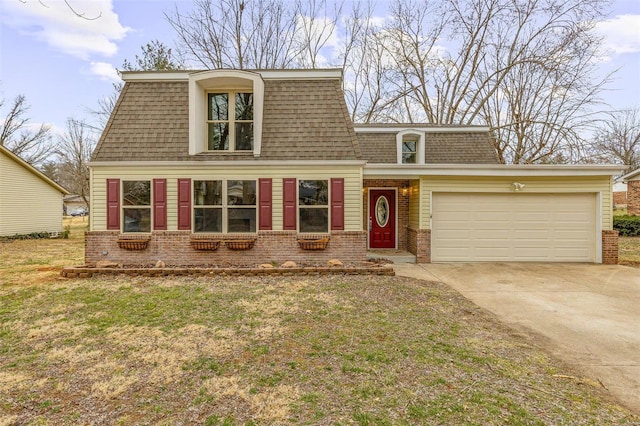 view of front of property featuring driveway, a shingled roof, mansard roof, and brick siding