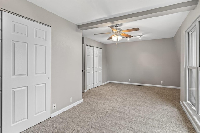 unfurnished bedroom with ceiling fan, carpet floors, a closet, and baseboards