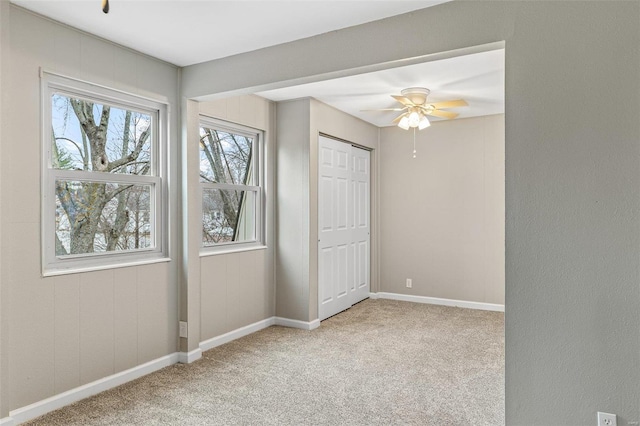 unfurnished bedroom with carpet, baseboards, and ceiling fan