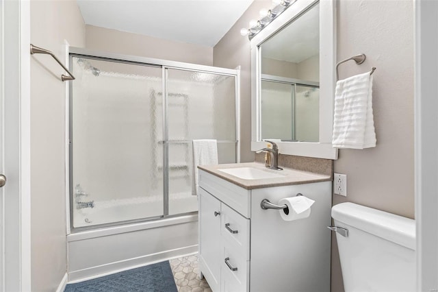 full bath featuring toilet, enclosed tub / shower combo, and vanity