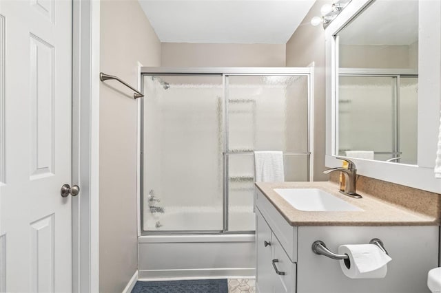 bathroom featuring enclosed tub / shower combo and vanity