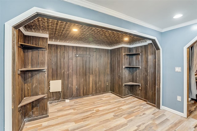 unfurnished room featuring crown molding, baseboards, recessed lighting, wood finished floors, and arched walkways