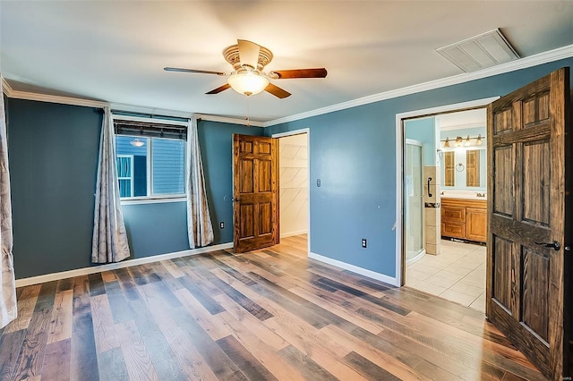 unfurnished bedroom with visible vents, light wood-style flooring, a ceiling fan, crown molding, and baseboards