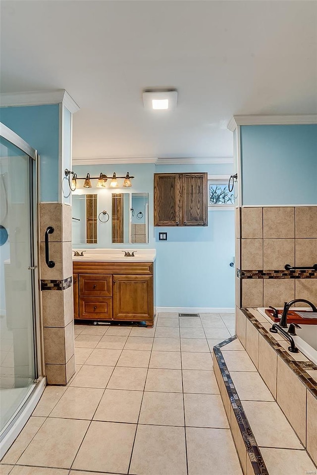 full bathroom featuring a stall shower, ornamental molding, a sink, and tile patterned flooring