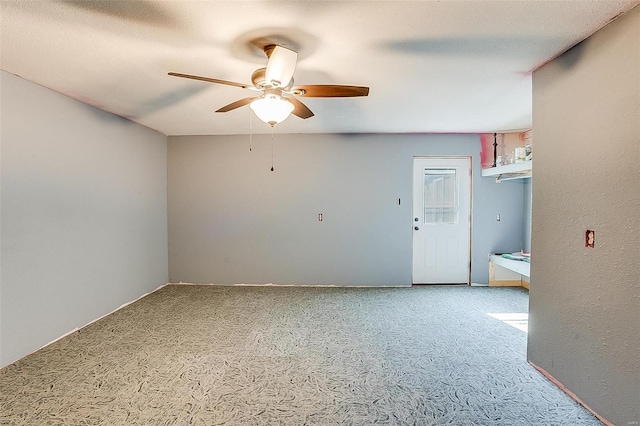 carpeted empty room featuring ceiling fan