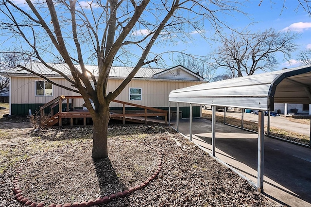 view of side of property featuring a detached carport and a deck