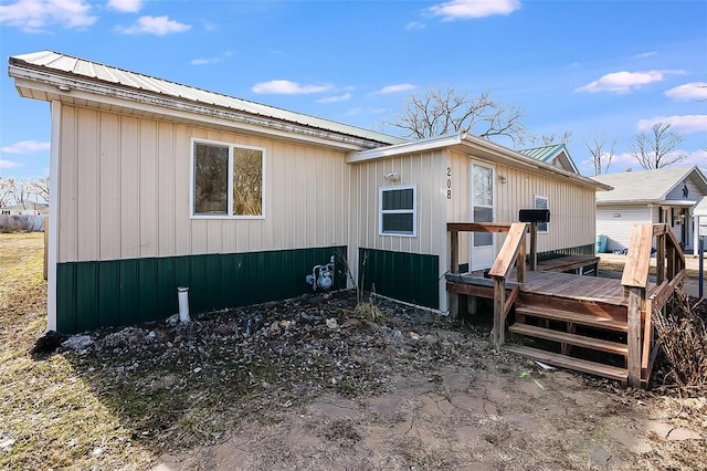 exterior space with a deck and metal roof