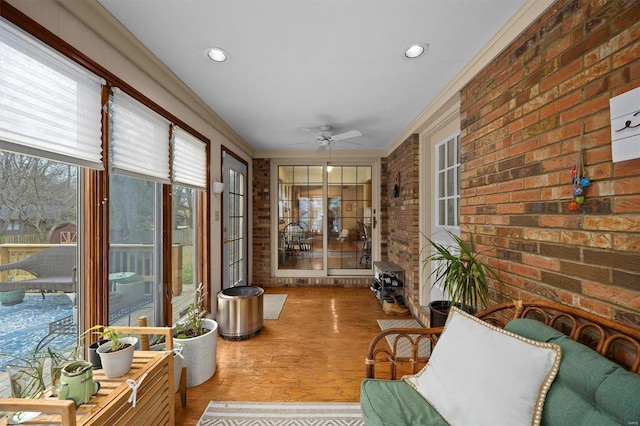 sunroom featuring a ceiling fan