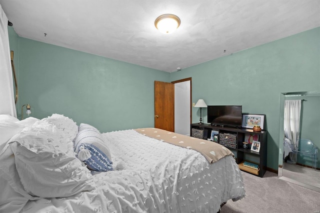 carpeted bedroom featuring baseboards