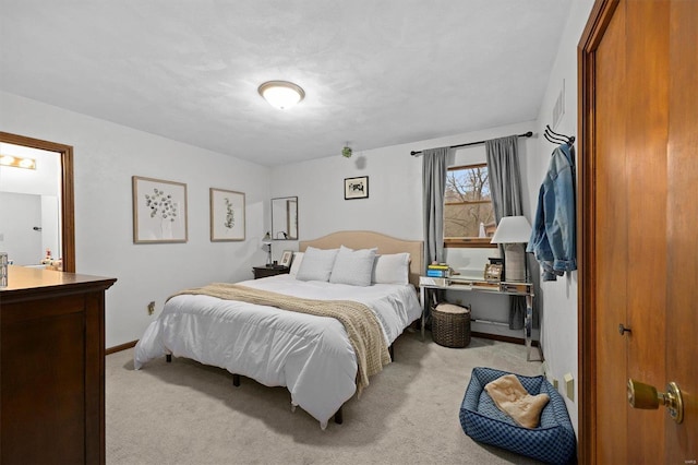 bedroom featuring light carpet, visible vents, and baseboards