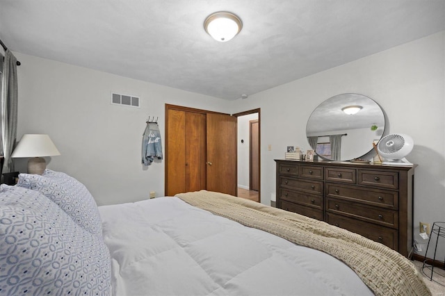 bedroom featuring visible vents and a closet