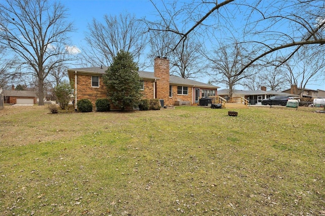 exterior space featuring brick siding, a chimney, and a front lawn