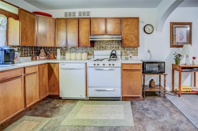 kitchen featuring under cabinet range hood, white appliances, tasteful backsplash, and light countertops