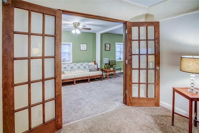 unfurnished room featuring a ceiling fan and carpet floors