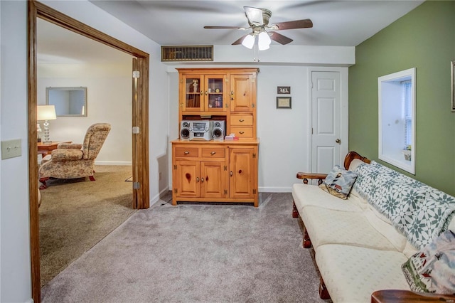 carpeted living room featuring visible vents, ceiling fan, and baseboards