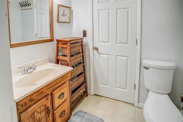 bathroom featuring tile patterned flooring, toilet, and vanity