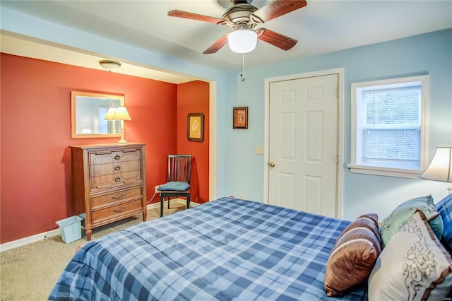 carpeted bedroom featuring a ceiling fan and baseboards