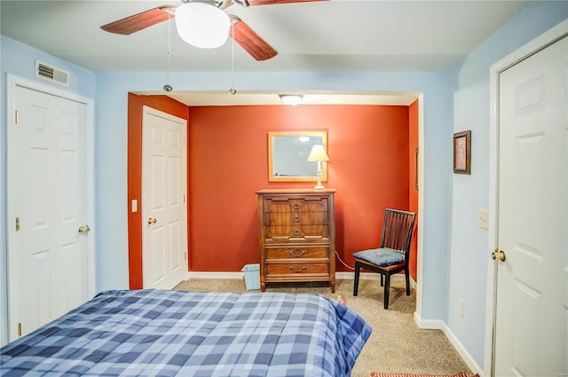 bedroom with visible vents, baseboards, carpet, and a ceiling fan