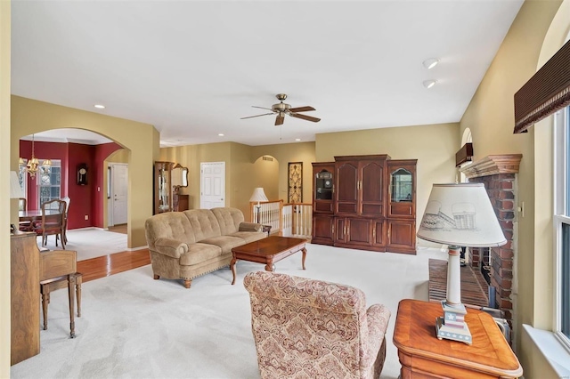 living area with arched walkways, carpet flooring, ceiling fan, and recessed lighting