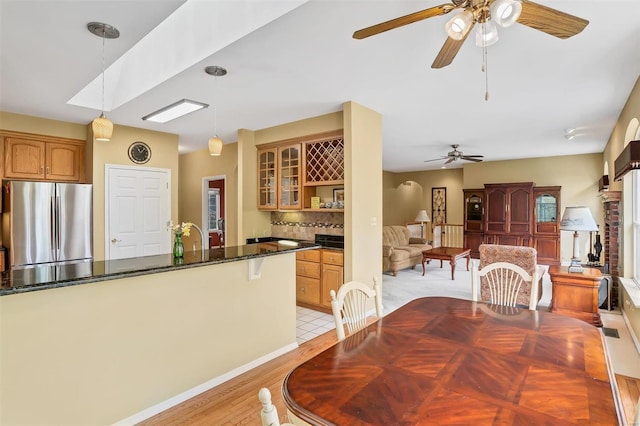 dining space featuring a ceiling fan and light wood-style floors