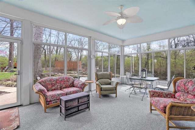 sunroom featuring ceiling fan and an outdoor living space