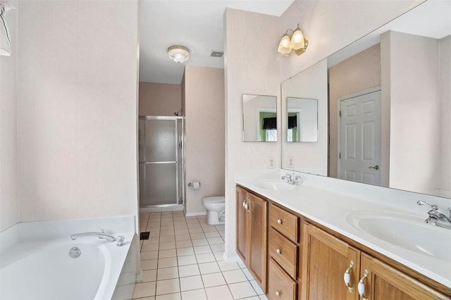 bathroom featuring tile patterned flooring, a shower stall, toilet, and a sink
