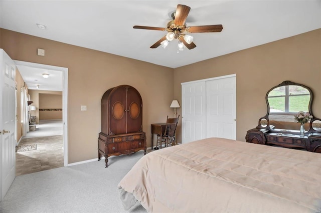 bedroom featuring carpet, a closet, a ceiling fan, and baseboards