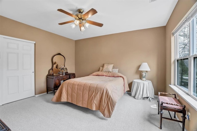 carpeted bedroom with baseboards and ceiling fan