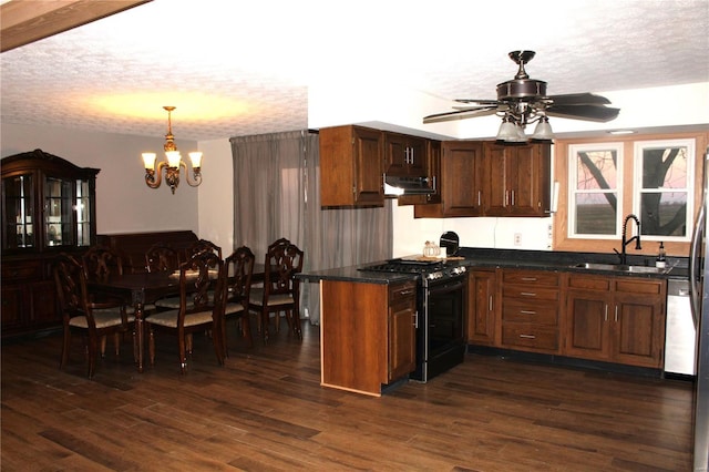 kitchen featuring a textured ceiling, black range with gas stovetop, dark wood-style flooring, and a sink