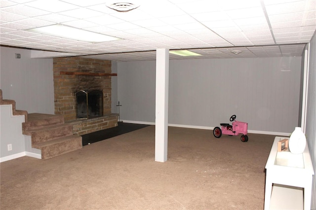 finished basement featuring stairs, carpet floors, a fireplace, and baseboards