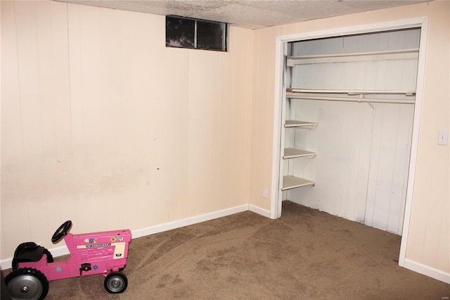 interior space with carpet floors, a closet, and baseboards