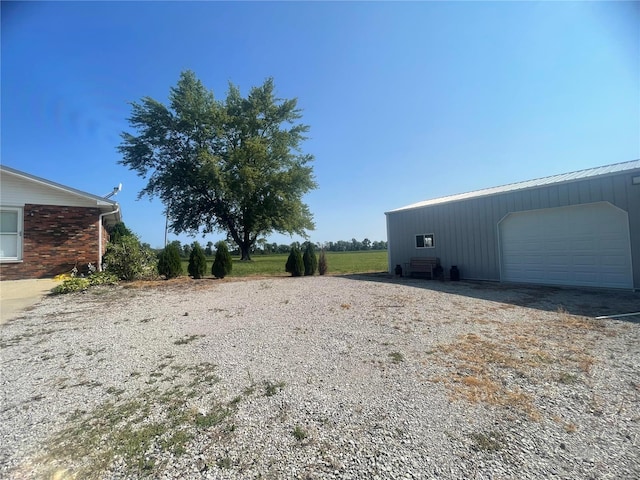 view of yard with an outbuilding and a detached garage