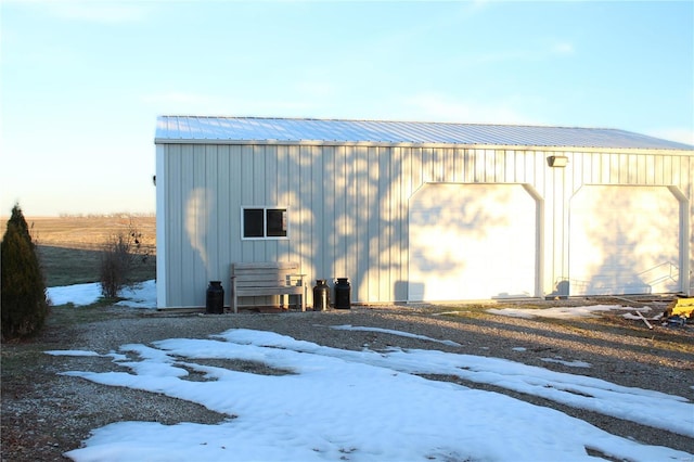 snow covered structure featuring an outdoor structure