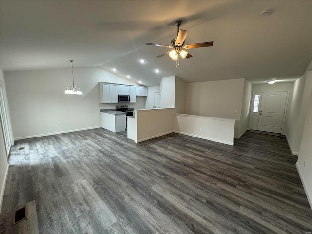 kitchen with open floor plan, stainless steel appliances, ceiling fan with notable chandelier, and lofted ceiling