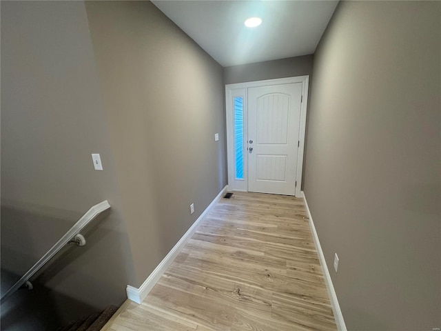 entryway with light wood-type flooring and baseboards